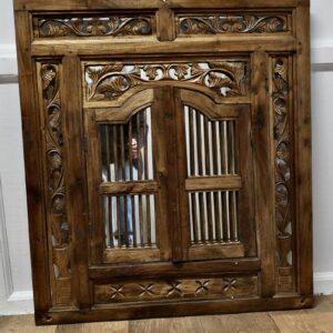 Wall Mirror Concealed by Heavy Carved Teak Door Shutters